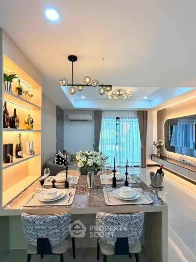 Luxurious dining area with elegant decor and modern lighting in a stylish home interior.