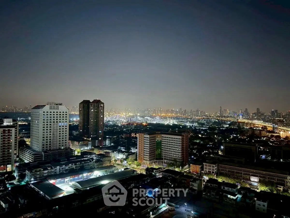 Stunning cityscape view from high-rise building at night with sparkling city lights.