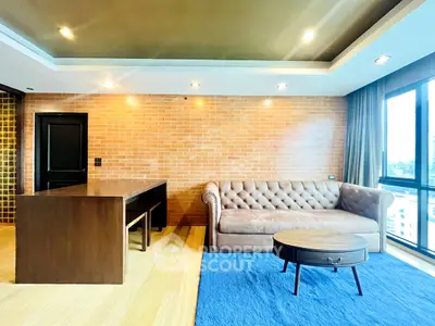 Stylish modern living room with brick accent wall and plush sofa, featuring a large window with city view.