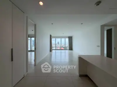 Spacious modern living room with city view and sleek tile flooring