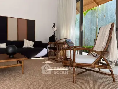 Stylish living room with modern furniture and natural light, featuring a cozy seating area and elegant decor.