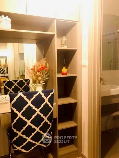 Cozy study nook with stylish chair and shelving in modern apartment