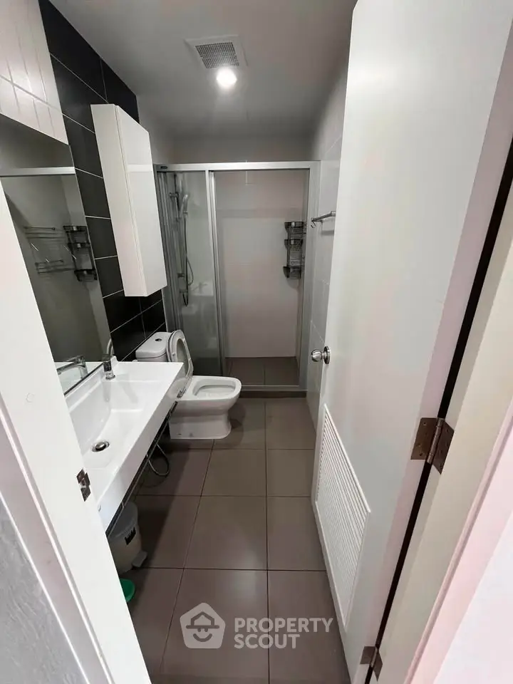Modern bathroom with sleek fixtures and glass shower enclosure