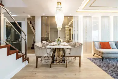 Luxurious modern dining area with elegant chandelier and stylish decor