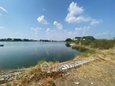 Scenic waterfront view with clear skies and distant buildings, perfect for serene living.