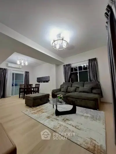Spacious living room with modern furniture and elegant lighting