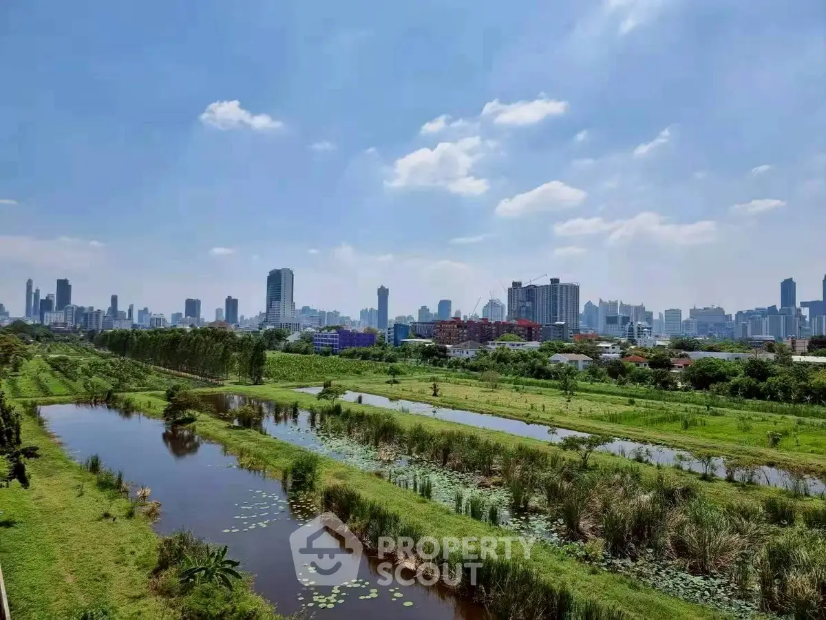 Stunning cityscape view with lush greenery and serene water bodies, perfect for urban nature lovers.