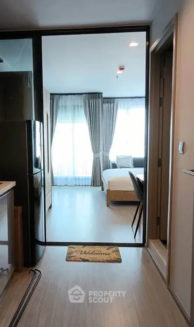 Modern studio apartment with open layout and stylish decor, featuring a cozy bedroom and sleek kitchen area.