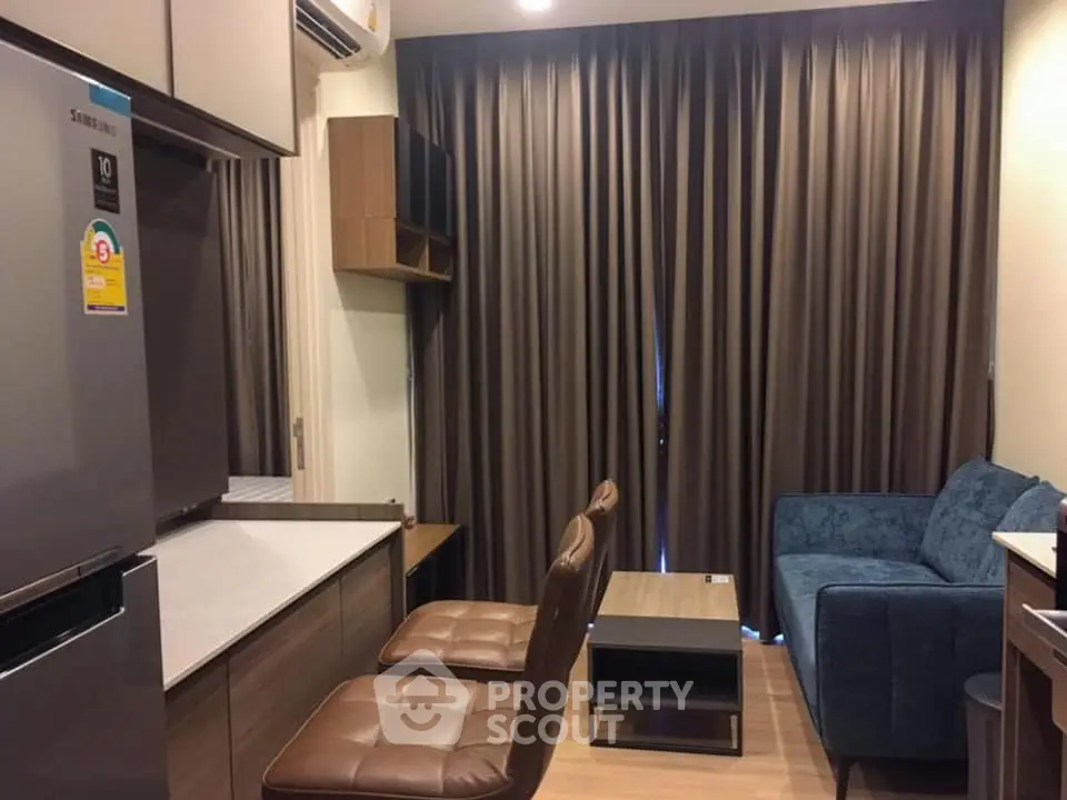 Modern compact living room with stylish furniture and large curtains