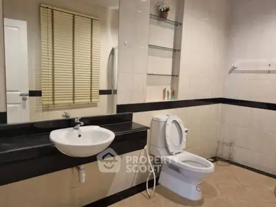 Spacious modern bathroom with sleek fixtures and large mirror