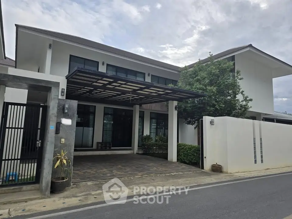 Modern two-story house with sleek design and spacious driveway in a serene neighborhood.