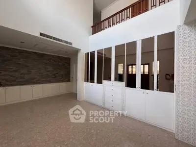 Spacious modern living room with high ceiling and elegant design