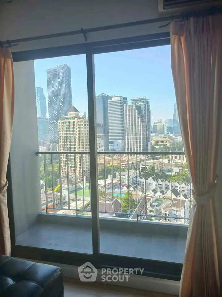 Stunning cityscape view from a high-rise apartment balcony with modern skyline.