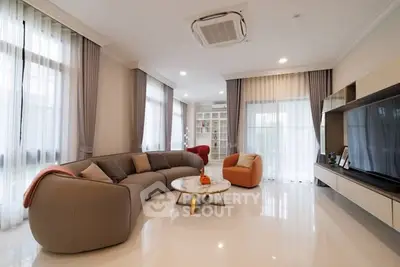 Spacious modern living room with elegant furniture and large windows