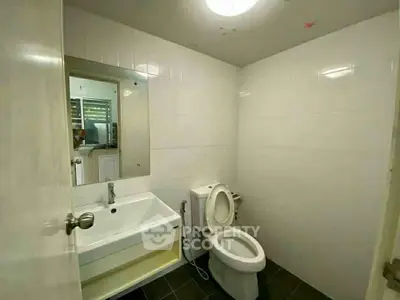 Modern bathroom with sleek white tiles and contemporary fixtures