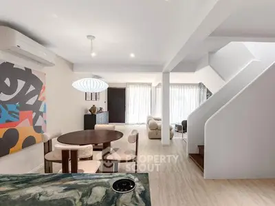 Modern open-plan living room with stylish decor and natural light