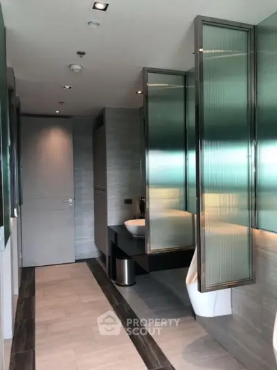 Modern bathroom with sleek design and frosted glass partitions