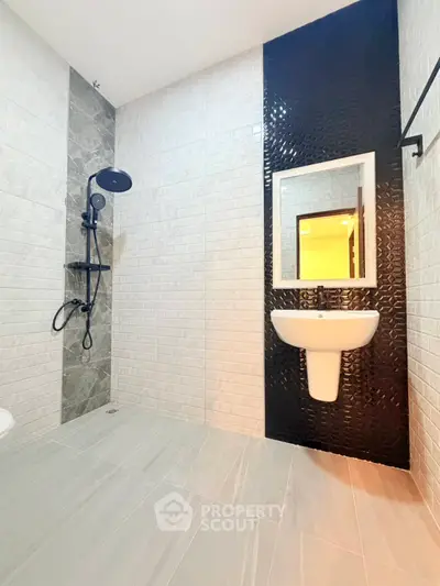 Modern bathroom with sleek black shower and stylish tile design