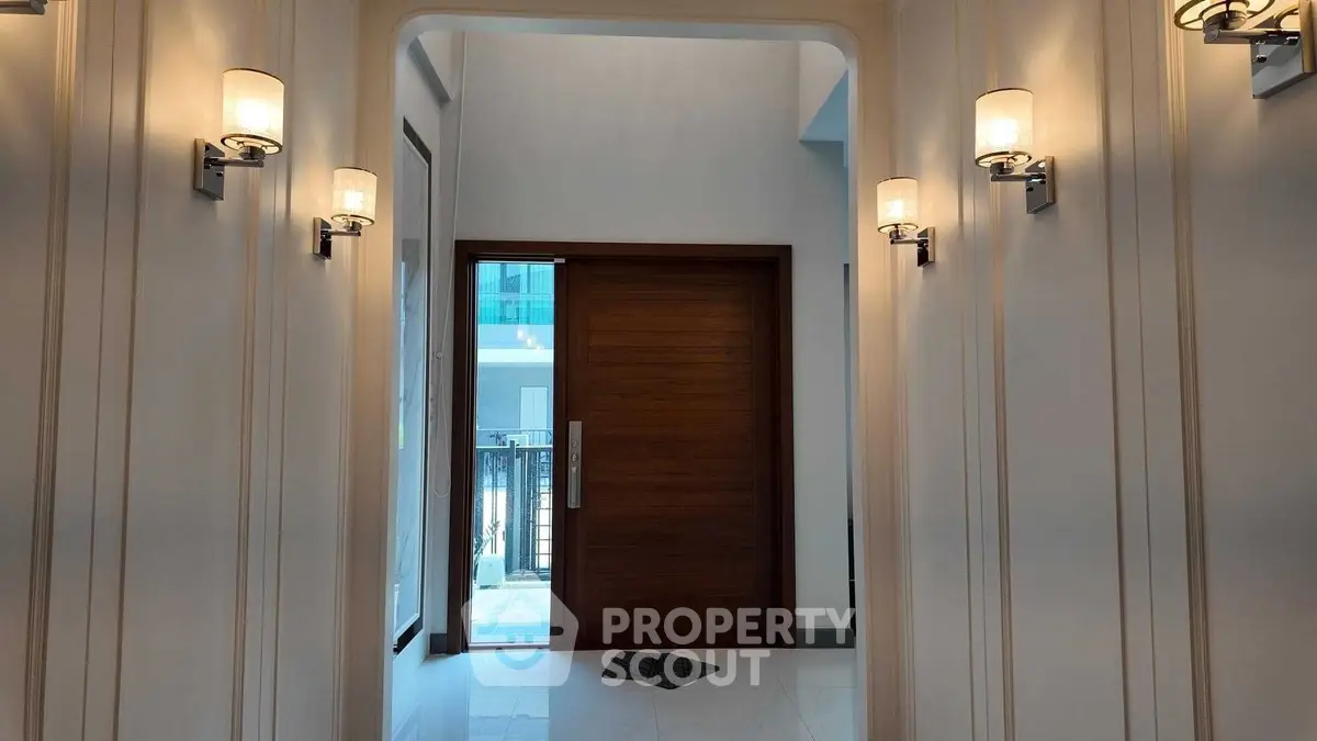 Elegant entrance with modern lighting and wooden door