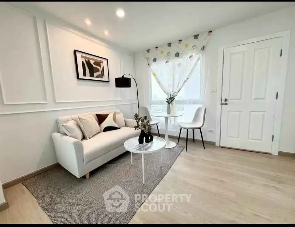 Charming living room with modern decor and cozy seating area, perfect for relaxation.