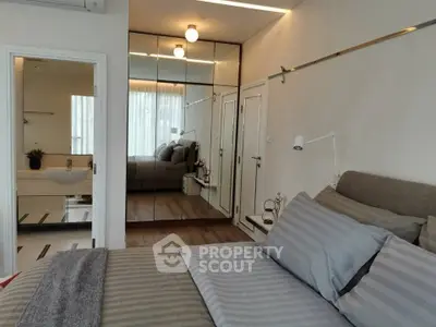 Modern bedroom with mirrored closet and stylish decor