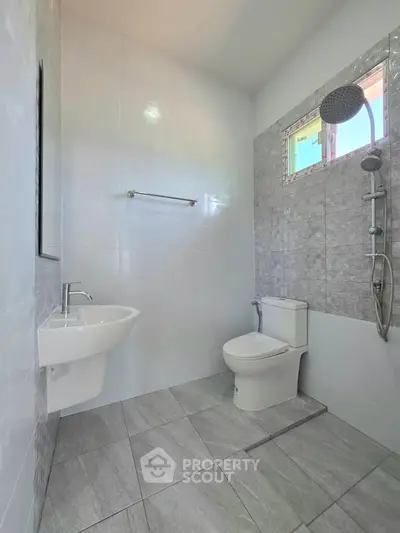 Modern bathroom with sleek shower and toilet in minimalist design