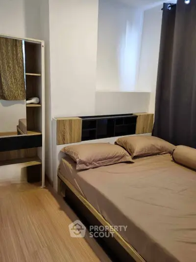 Cozy bedroom with modern furnishings and natural light, perfect for relaxation and comfort.