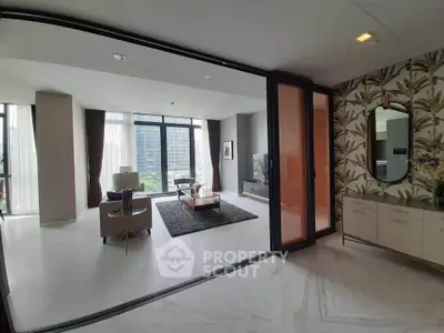 Luxurious modern living room with large windows and elegant decor in a high-rise apartment.