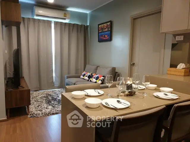 Modern living room with cozy sofa, dining area, and stylish decor in a contemporary apartment.