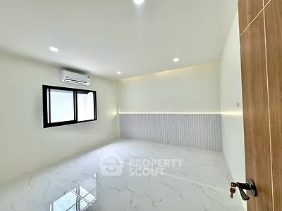 Spacious modern room with glossy tiled floor and air conditioning, perfect for a stylish living space.