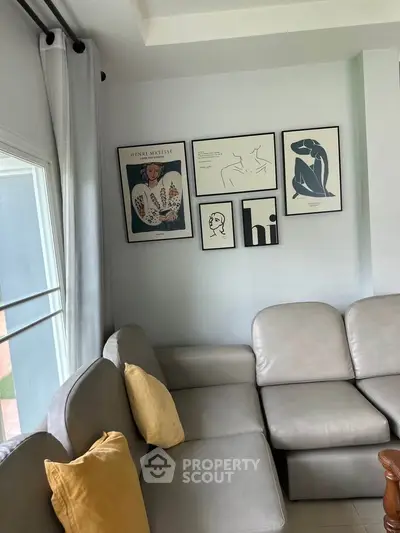 Stylish living room with modern art and cozy gray sofa
