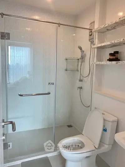 Modern bathroom with glass shower and sleek fixtures