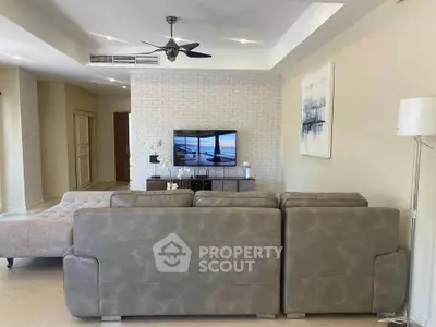 Spacious living room with modern decor and comfortable seating