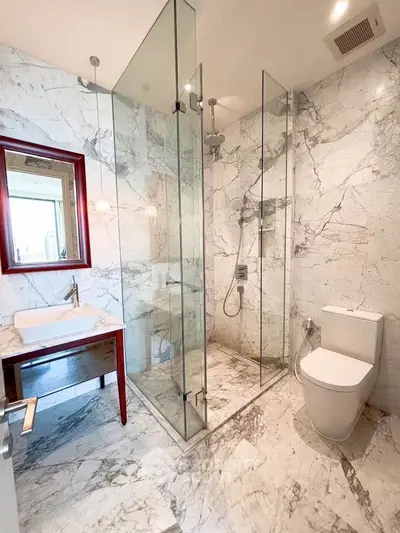 Luxurious marble bathroom with glass shower and modern fixtures