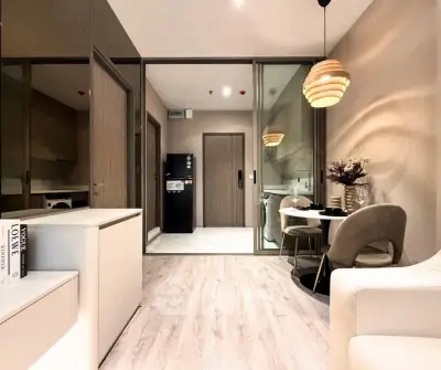 Modern open-plan living room with stylish dining area and sleek kitchen design.