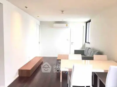 Modern living room with sleek furniture and air conditioning, featuring a minimalist design.