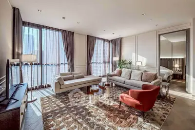 Luxurious living room with modern furniture and large windows in a high-end apartment.