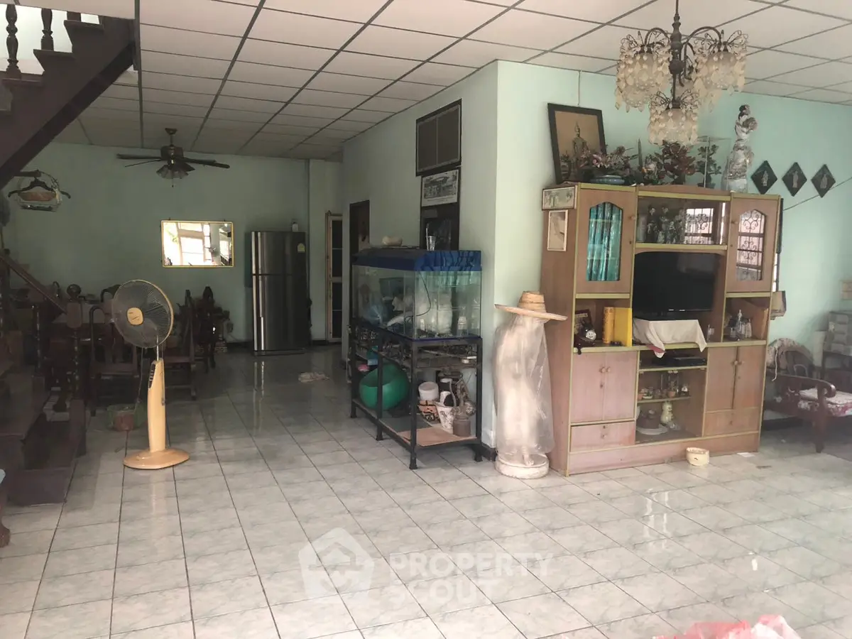 Spacious living room with tiled floor and eclectic decor