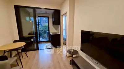 Modern living room with balcony access and sleek furnishings in urban apartment.