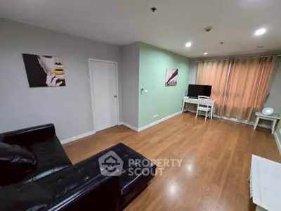 Spacious living room with modern decor and wooden flooring