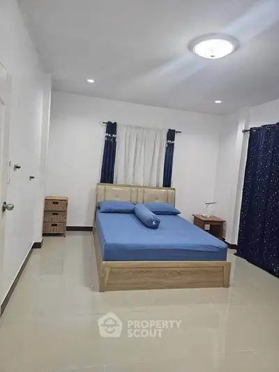 Spacious bedroom with modern decor and natural light