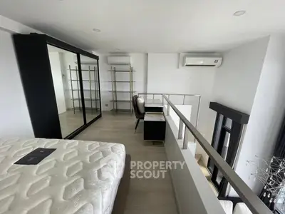 Modern loft bedroom with stylish decor and large mirror wardrobe