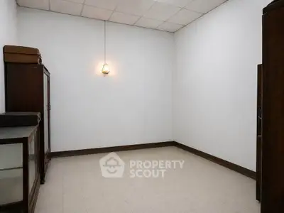 Minimalist empty room with vintage wooden furniture and pendant light