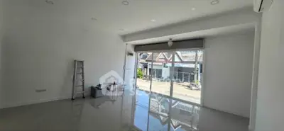 Spacious empty room with large window and glossy floor, perfect for customization.