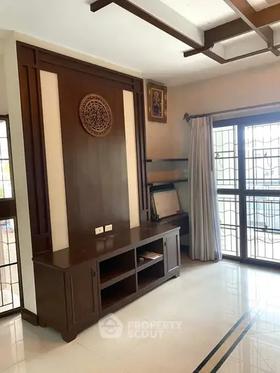 Elegant living room with wooden accents and large windows for natural light.