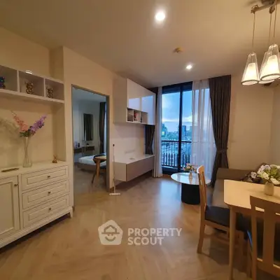 Charming open-plan living room with dining area and city view balcony, perfect for modern urban living.