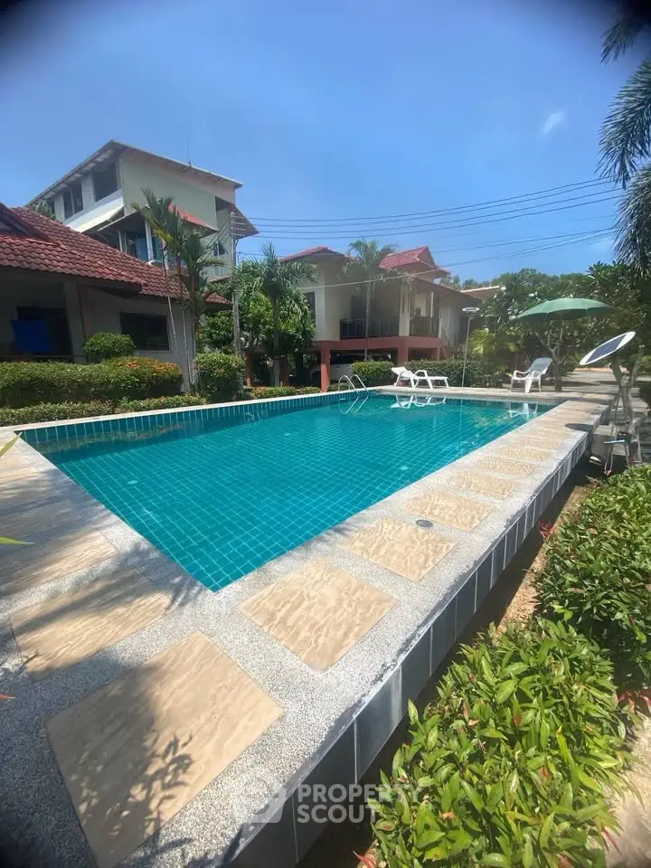 Stunning residential pool area with lush greenery and modern design, perfect for relaxation and leisure.