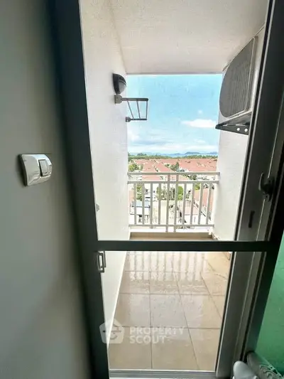 Charming balcony with scenic view of rooftops and clear sky, perfect for relaxation.