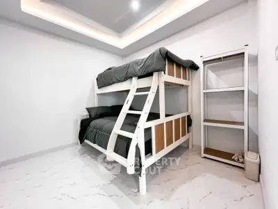 Modern bedroom with stylish bunk bed and sleek shelving unit, perfect for maximizing space and comfort.