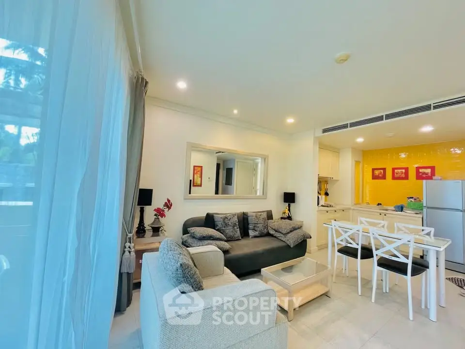 Spacious living room with modern decor and open kitchen layout